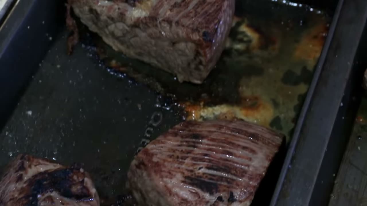 La carne dorada en la bandeja del horno